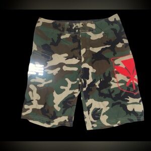 Wailoa "Green Camo Kanaka" Boys board shorts. 
Size boys 14  Inseam 11”